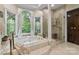 Spa-like bathroom with a large soaking tub, walk-in shower, and stained glass windows at 1090 N Saunders Dr, Catawba, NC 28609