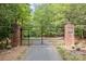 Brick pillars and metal gate open to a tree-lined driveway at 1090 N Saunders Dr, Catawba, NC 28609