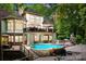 Two-story house with stone accents, a large deck, and a luxurious pool and waterfall feature at 1090 N Saunders Dr, Catawba, NC 28609