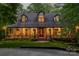Two-story home with wrap-around porch, lit at dusk at 1090 N Saunders Dr, Catawba, NC 28609