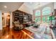 Spacious living room with hardwood floors, built-in shelving, and large windows at 1090 N Saunders Dr, Catawba, NC 28609