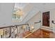 Bright and spacious upstairs hall with hardwood floors and a large chandelier at 1090 N Saunders Dr, Catawba, NC 28609