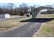 Gravel driveway leading to various outbuildings and a carport at 1219 Burke Rd, Shelby, NC 28152