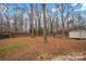 Large backyard with mature trees and a storage shed at 132 Holman Rd, Statesville, NC 28677