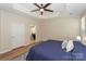 Bright main bedroom with hardwood floors, ceiling fan, and access to bathroom at 139 Welcombe St, Mooresville, NC 28115