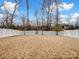 Fenced backyard with dry grass and white vinyl fence at 1414 Kings Grove Dr, York, SC 29745