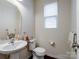 Clean bathroom with pedestal sink, toilet, and dark wood flooring at 1414 Kings Grove Dr, York, SC 29745