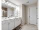 Double vanity, large mirror, and neutral tile flooring at 1414 Kings Grove Dr, York, SC 29745