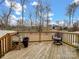 Wooden deck overlooks fenced backyard with trees at 1414 Kings Grove Dr, York, SC 29745