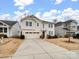 Two-story house with beige siding, a two-car garage, and a well-manicured lawn at 1414 Kings Grove Dr, York, SC 29745