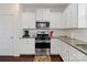 White kitchen with stainless steel appliances and granite countertops at 1414 Kings Grove Dr, York, SC 29745