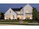 Stunning two-story white farmhouse with nighttime lighting at 2026 Thatcher Way, Fort Mill, SC 29715