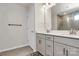 Bathroom featuring double sink vanity with modern fixtures and tiled flooring at 23010 Clarabelle Dr, Charlotte, NC 28273