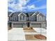 Charming townhome with a two-car garage and gray siding offers modern curb appeal at 23010 Clarabelle Dr, Charlotte, NC 28273