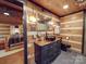 Black sink and modern lighting in rustic log cabin bathroom at 2577 Dutch Rd, Mount Pleasant, NC 28124