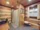 Rustic bathroom with log cabin walls, a walk-in shower, and modern sink at 2577 Dutch Rd, Mount Pleasant, NC 28124