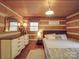 Charming bedroom with log walls, a queen bed, and white dresser at 2577 Dutch Rd, Mount Pleasant, NC 28124