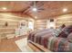 Spacious bedroom with log cabin walls, ceiling fan, and ample natural light at 2577 Dutch Rd, Mount Pleasant, NC 28124