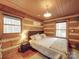Cozy bedroom with log walls and a comfortable bed at 2577 Dutch Rd, Mount Pleasant, NC 28124