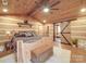 King bed in a cozy log cabin bedroom with barn door access to the bathroom at 2577 Dutch Rd, Mount Pleasant, NC 28124