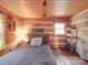 Rustic bedroom with log walls and a full-size bed at 2577 Dutch Rd, Mount Pleasant, NC 28124
