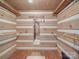 Large walk-in closet with rustic log cabin walls and ample hanging space at 2577 Dutch Rd, Mount Pleasant, NC 28124