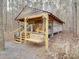 Charming log cabin with a porch swing in a wooded setting at 2577 Dutch Rd, Mount Pleasant, NC 28124