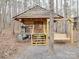 Rustic log cabin exterior with porch swing and grill at 2577 Dutch Rd, Mount Pleasant, NC 28124