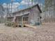 Log cabin with wraparound porch, American flag, and ramp access at 2577 Dutch Rd, Mount Pleasant, NC 28124
