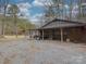 Detached garage with covered carport and gravel parking area at 2577 Dutch Rd, Mount Pleasant, NC 28124