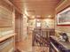 Rustic hallway with log walls, wood floors, and a staircase at 2577 Dutch Rd, Mount Pleasant, NC 28124