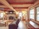 Relaxing living room featuring a stone fireplace and log cabin charm at 2577 Dutch Rd, Mount Pleasant, NC 28124