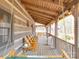 Relaxing covered porch with wooden swing and comfortable seating at 2577 Dutch Rd, Mount Pleasant, NC 28124