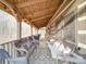Cozy covered porch features wicker furniture and string lights at 2577 Dutch Rd, Mount Pleasant, NC 28124