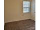 Well-lit bedroom with window, closet, and neutral walls at 4612 Waterbell Ln, Waxhaw, NC 28173