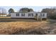 Single-wide manufactured home with brick skirt, new wooden steps and a landscaped yard at 48252 Hwy 731 Hwy, Norwood, NC 28128