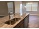 Kitchen island with double sink, granite countertop, and modern faucet at 5126 Rocky River Crossing Rd, Harrisburg, NC 28075