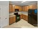 Kitchen with wood cabinets, black appliances, and tile flooring at 536 Bent Leaf Ct, Fort Mill, SC 29708