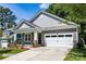 Craftsman style home with gray siding, white garage door, and landscaping at 600 Banter Ln # 27, Cramerton, NC 28032