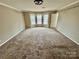 Spacious bedroom with a large window and walk-in closet at 701 Victorian Ln, Monroe, NC 28112