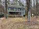 Two-story house with a wraparound porch, surrounded by trees at 701 Victorian Ln, Monroe, NC 28112