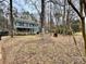 Two-story house with a wraparound porch, nestled in a wooded area at 701 Victorian Ln, Monroe, NC 28112