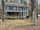 Two-story house with a wraparound porch, surrounded by trees at 701 Victorian Ln, Monroe, NC 28112