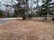 Residential front yard with tree and leaf covered ground at 701 Victorian Ln, Monroe, NC 28112