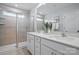 Bright bathroom featuring double sinks, white cabinetry, and a glass-enclosed shower at 7232 Hodges Meadow Ln, Charlotte, NC 28213