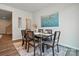 Cozy dining room featuring a stylish table set, hardwood floors, and modern art adding to the ambiance at 7232 Hodges Meadow Ln, Charlotte, NC 28213