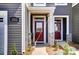 Inviting front facade showcasing a charming entrance with stone accents and manicured landscaping at 7232 Hodges Meadow Ln, Charlotte, NC 28213