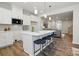 Modern kitchen with a large island, pendant lighting, and sleek countertops, seamlessly flowing into the living area at 7232 Hodges Meadow Ln, Charlotte, NC 28213