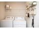 Convenient laundry room with washer and dryer, and stylish shelving at 7232 Hodges Meadow Ln, Charlotte, NC 28213