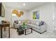 Inviting living room features a gray sectional sofa, stylish decor, and ample natural light at 7232 Hodges Meadow Ln, Charlotte, NC 28213